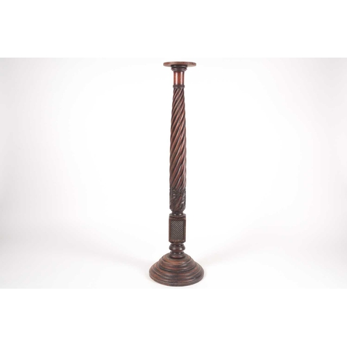 168 - A George IV carved and turned bedpost torchere with wrythen column. On turned conical base. 122 cm h... 