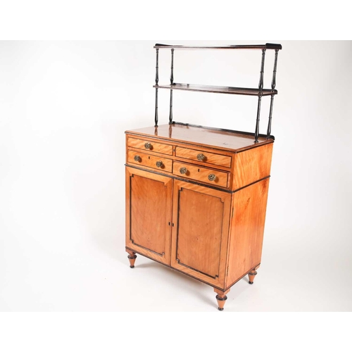 169 - A Regency ebonised and figured satinwood chiffonier with a fitted secretaire frieze drawer, with sup... 