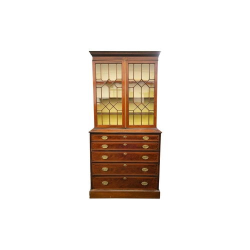 177 - A George III mahogany secretaire bookcase. The upper section with a pair of geometrically glazed doo... 