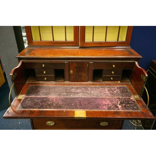 177 - A George III mahogany secretaire bookcase. The upper section with a pair of geometrically glazed doo... 