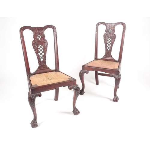 180 - A pair of 18th century American, Pennsylvanian 'Queen Anne' walnut side chairs, the splats pierced a... 