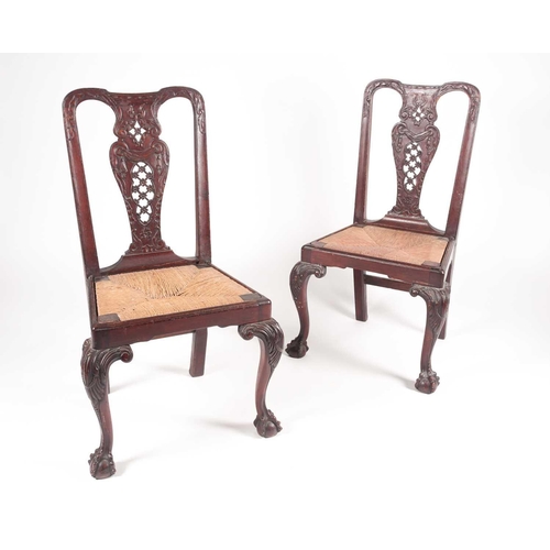 180 - A pair of 18th century American, Pennsylvanian 'Queen Anne' walnut side chairs, the splats pierced a... 