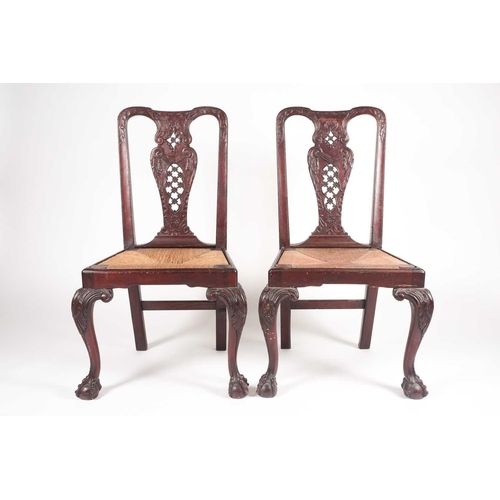 180 - A pair of 18th century American, Pennsylvanian 'Queen Anne' walnut side chairs, the splats pierced a... 