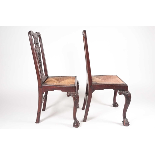 180 - A pair of 18th century American, Pennsylvanian 'Queen Anne' walnut side chairs, the splats pierced a... 