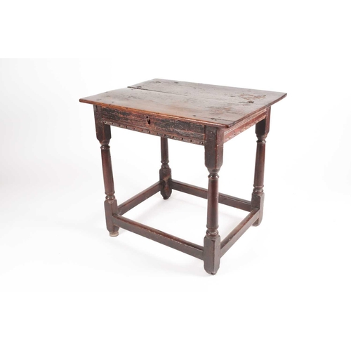 185 - A late 17th-century oak single drawer side table. With planked top. On turned spindle supports unite... 