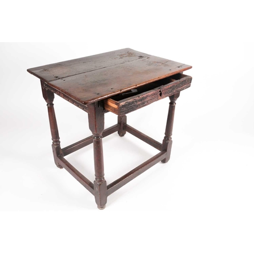 185 - A late 17th-century oak single drawer side table. With planked top. On turned spindle supports unite... 