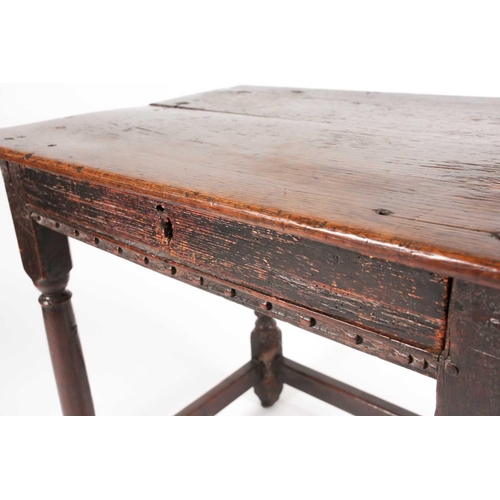 185 - A late 17th-century oak single drawer side table. With planked top. On turned spindle supports unite... 