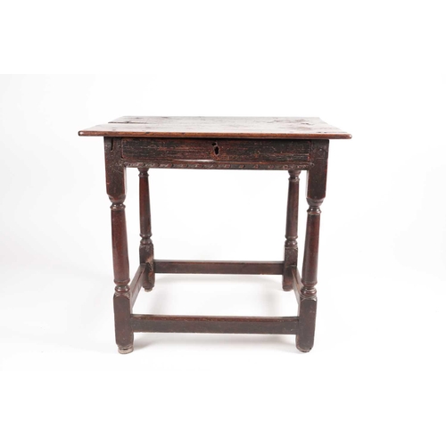 185 - A late 17th-century oak single drawer side table. With planked top. On turned spindle supports unite... 