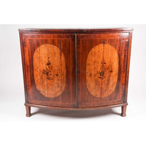 208 - A George III satinwood crossbanded mahogany bowfront two-door drawing room cabinet, the shaped doors... 