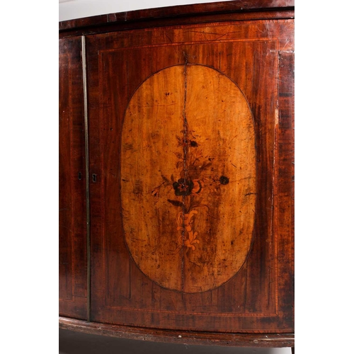 208 - A George III satinwood crossbanded mahogany bowfront two-door drawing room cabinet, the shaped doors... 