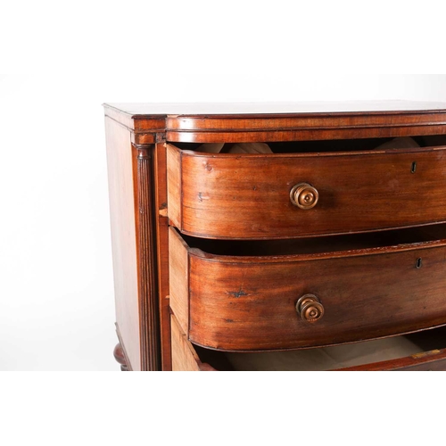 209 - A Regency figured mahogany break bow-fronted commode chest of three long drawers. The drawers flanke... 