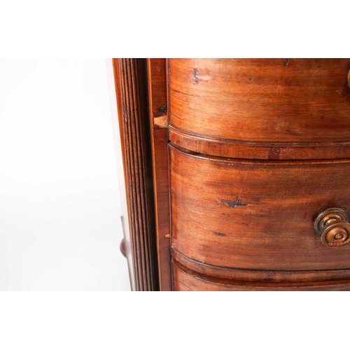 209 - A Regency figured mahogany break bow-fronted commode chest of three long drawers. The drawers flanke... 