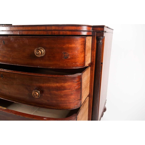 209 - A Regency figured mahogany break bow-fronted commode chest of three long drawers. The drawers flanke... 