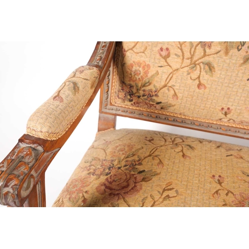 220 - An early 20th century, French Louis XVI style carved beechwood three seat sofa. With floral stuff ov... 