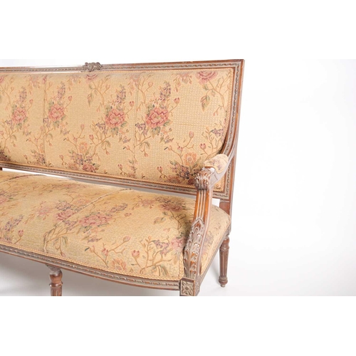 220 - An early 20th century, French Louis XVI style carved beechwood three seat sofa. With floral stuff ov... 