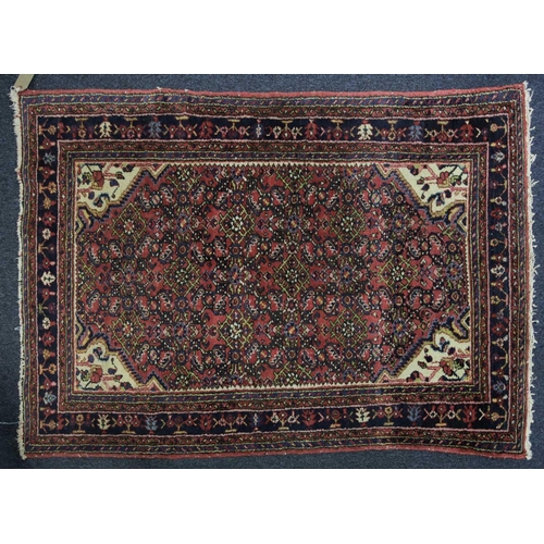 226 - A 20th century Lilihan? rug with a central lozenge field of stylized herat motif within multiple bor... 