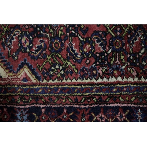 226 - A 20th century Lilihan? rug with a central lozenge field of stylized herat motif within multiple bor... 