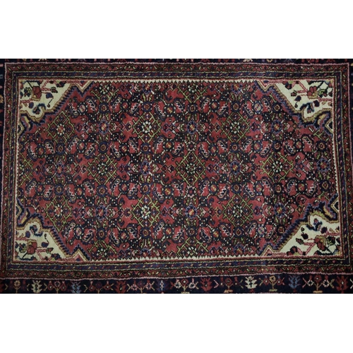 226 - A 20th century Lilihan? rug with a central lozenge field of stylized herat motif within multiple bor... 