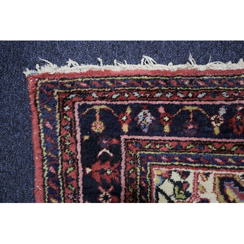 226 - A 20th century Lilihan? rug with a central lozenge field of stylized herat motif within multiple bor... 