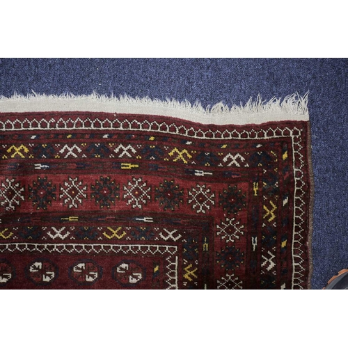 228 - A 20th century Turkomen rug with a lattice of guls on a madder red field within multiple borders. 19... 