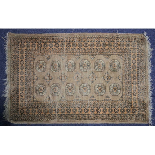 232 - A 20th century Turkish rug with diamond lozenges on a muted red ground within broad borders and frin... 
