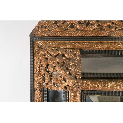 233A - A large 19th century Italian pressed brass cushion moulded wall mirror, with ornated figural and scr... 