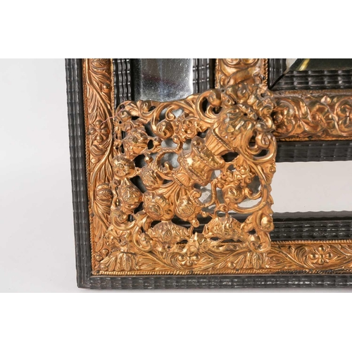 233A - A large 19th century Italian pressed brass cushion moulded wall mirror, with ornated figural and scr... 