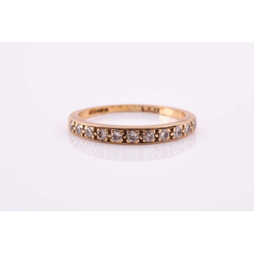 100A - An 18ct yellow gold band ring, pave-set with small round-cut diamonds, size O, 2 grams.