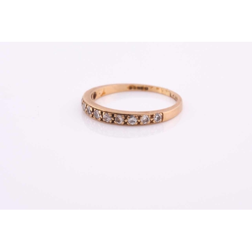 100A - An 18ct yellow gold band ring, pave-set with small round-cut diamonds, size O, 2 grams.