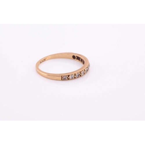 100A - An 18ct yellow gold band ring, pave-set with small round-cut diamonds, size O, 2 grams.
