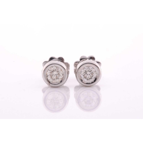 100 - A pair of collet-set diamond solitaire ear studs, set with round brilliant-cut diamonds of approxima... 
