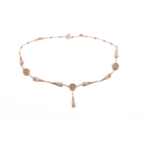 101 - A yellow metal and seed pearl drop pendant necklace, the pendants with filigree decoration and inset... 