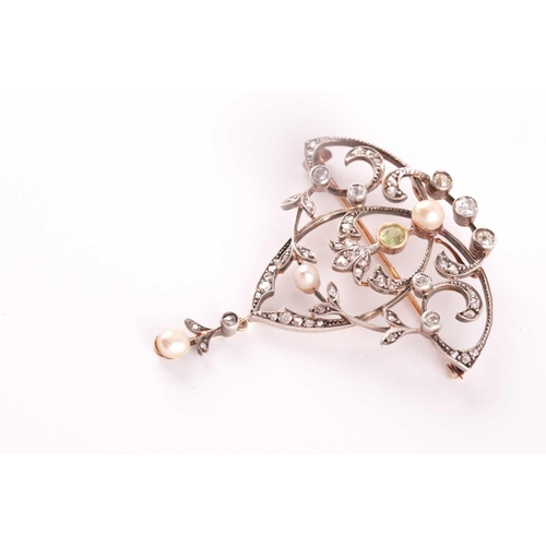 103 - A yellow and white metal, peridot, diamond and pearl brooch/pendant, the openwork art Nouveau style ... 