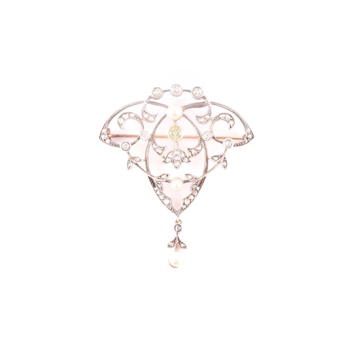 103 - A yellow and white metal, peridot, diamond and pearl brooch/pendant, the openwork art Nouveau style ... 
