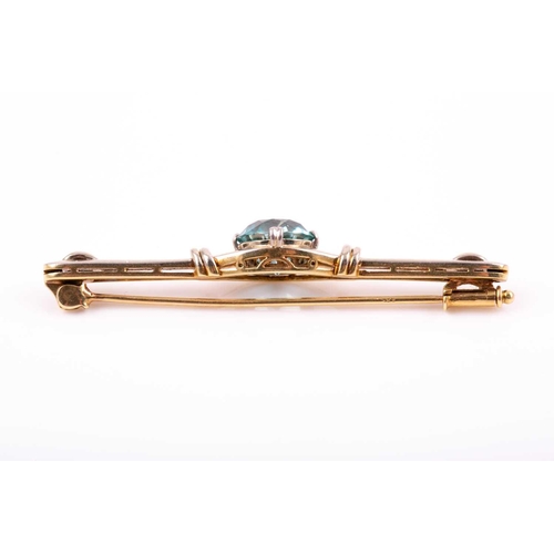 104 - A white and yellow gold and blue zircon brooch, set with a mixed round-cut zircon measuring approxim... 