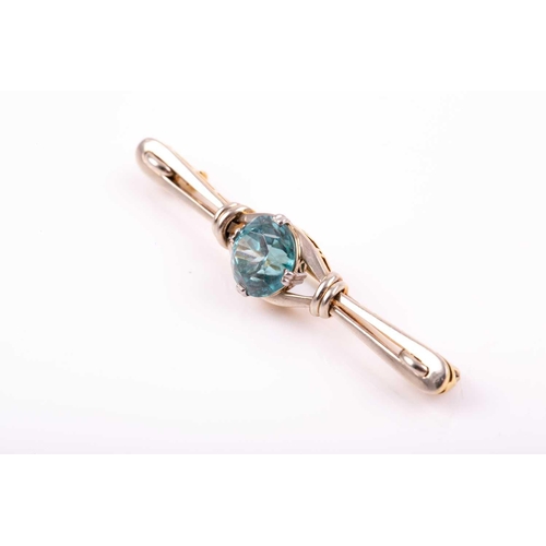 104 - A white and yellow gold and blue zircon brooch, set with a mixed round-cut zircon measuring approxim... 