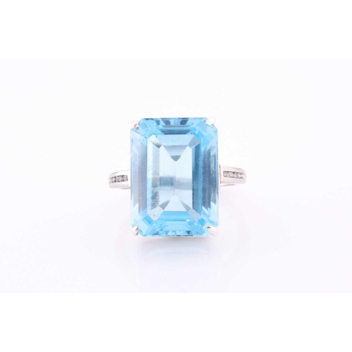 105 - A platinum, blue topaz and diamond dress ring, set with a mixed rectangular-cut topaz, of approximat... 