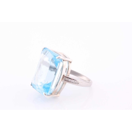 105 - A platinum, blue topaz and diamond dress ring, set with a mixed rectangular-cut topaz, of approximat... 