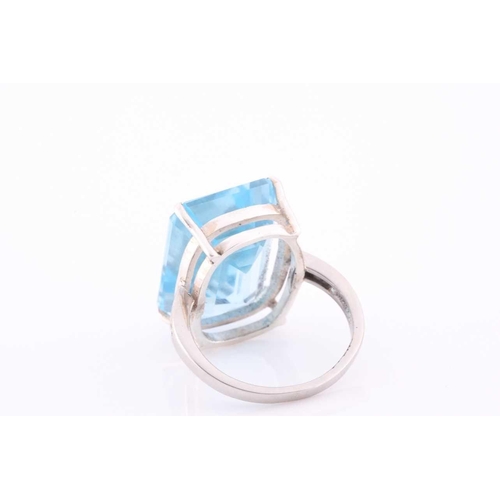 105 - A platinum, blue topaz and diamond dress ring, set with a mixed rectangular-cut topaz, of approximat... 