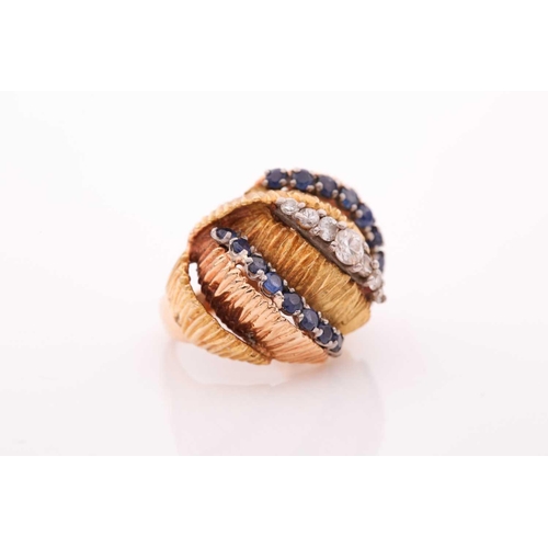 106 - A vintage sapphire and diamond dress ring - circa 1960; comprising rows of circular cut sapphires an... 