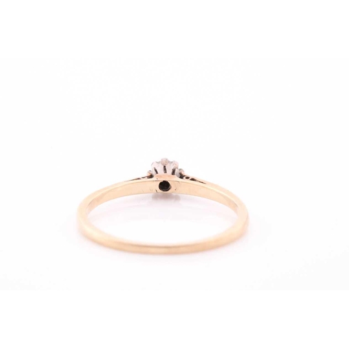 107 - A single stone synhetic corundum dress ring; the circular cut stone in six claw setting and heart-sh... 