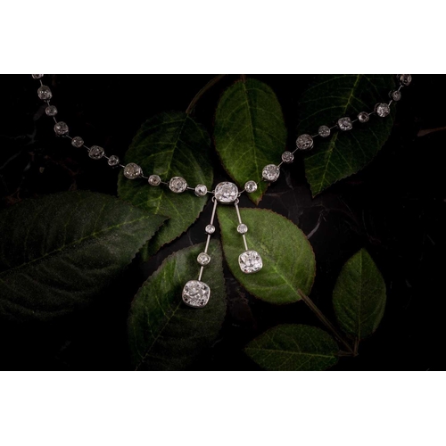 110 - An impressive antique collet-set diamond lavliere necklace, suspended with two old mine cut diamonds... 