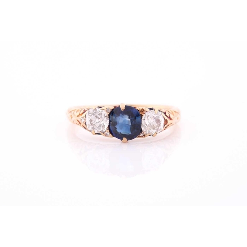 117 - A late 19th / early 20th century diamond and sapphire ring, the carved mount centred with a mixed ro... 