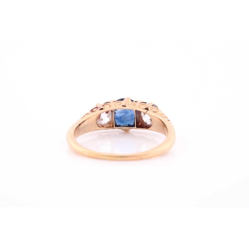 117 - A late 19th / early 20th century diamond and sapphire ring, the carved mount centred with a mixed ro... 