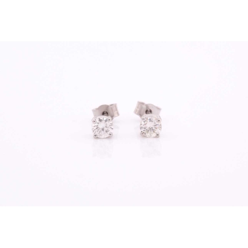 300 - A pair of platinum and diamond earrings, the round brilliant-cut diamonds of approximately 0.56 cara... 