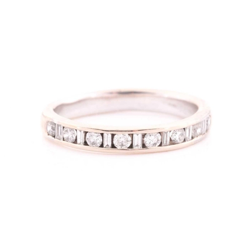 303 - An 18ct white gold and diamond half eternity ring, channel-set with alternating round and baguette-c... 