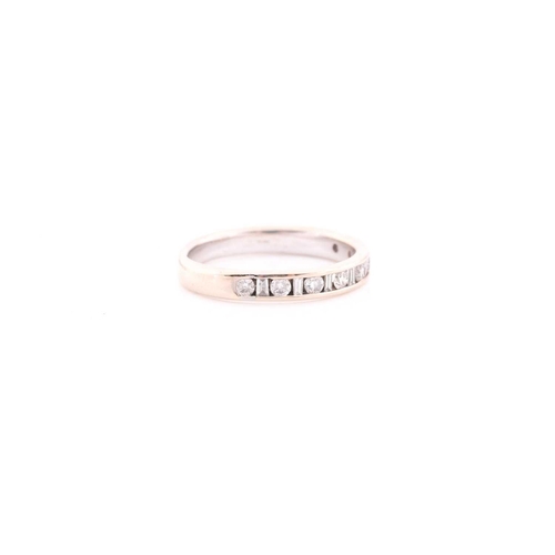 303 - An 18ct white gold and diamond half eternity ring, channel-set with alternating round and baguette-c... 