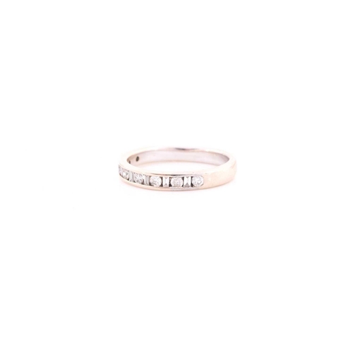 303 - An 18ct white gold and diamond half eternity ring, channel-set with alternating round and baguette-c... 