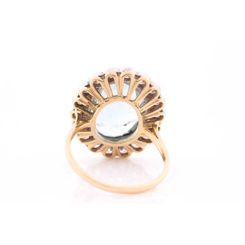 304 - An 18ct yellow gold, diamond, and aquamarine cocktail ring, set with a mixed oval-cut aquamarine of ... 