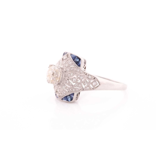 306 - An unusual diamond and sapphire ring, in the Art Deco style, centred with an old cushion-cut diamond... 